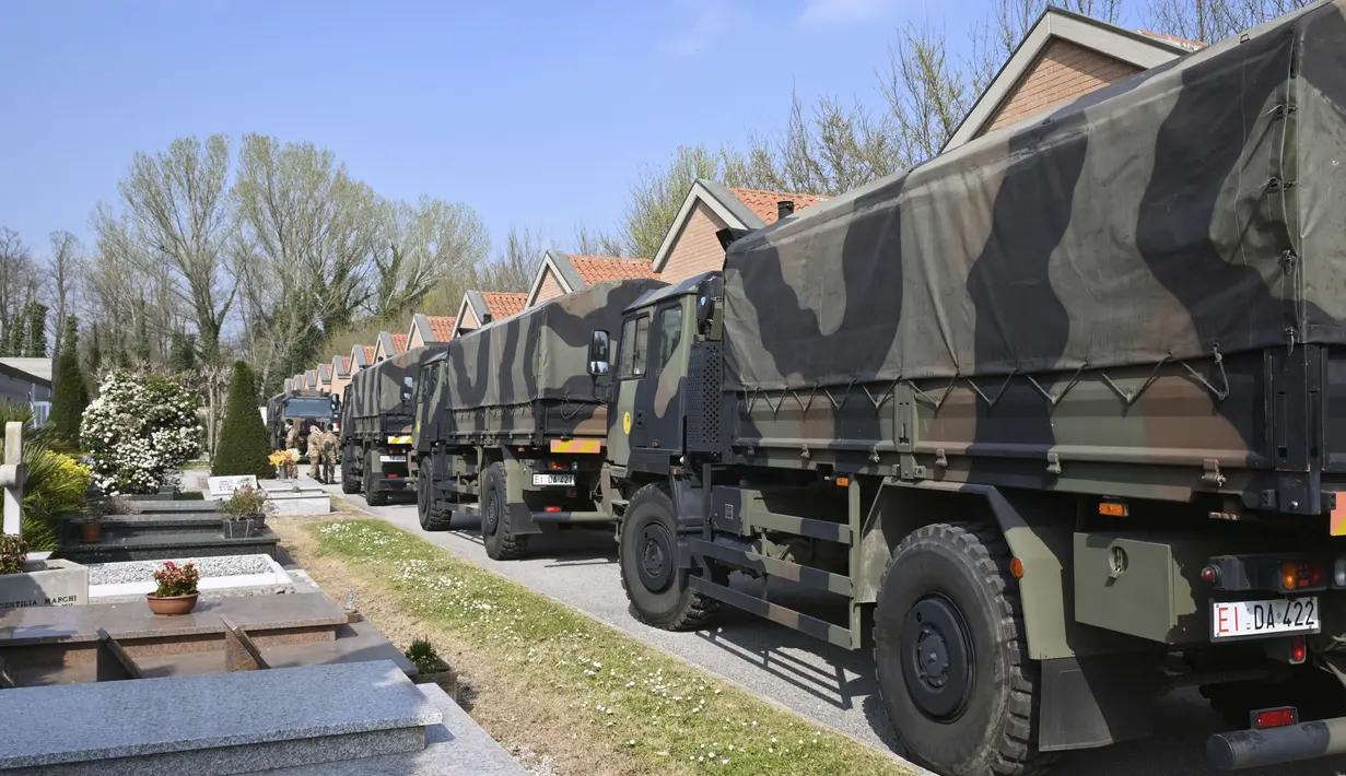 Konvoi truk militer yang membawa peti mati berisi jasad korban virus corona COVID-19 dari Bergamo tiba di Ferrara, Italia, Sabtu (21/3/2020). Italia mencatat kematian tertinggi akibat COVID-19 dalam sehari dengan 793 korban meninggal. (Massimo Paolone/LaPresse via AP)