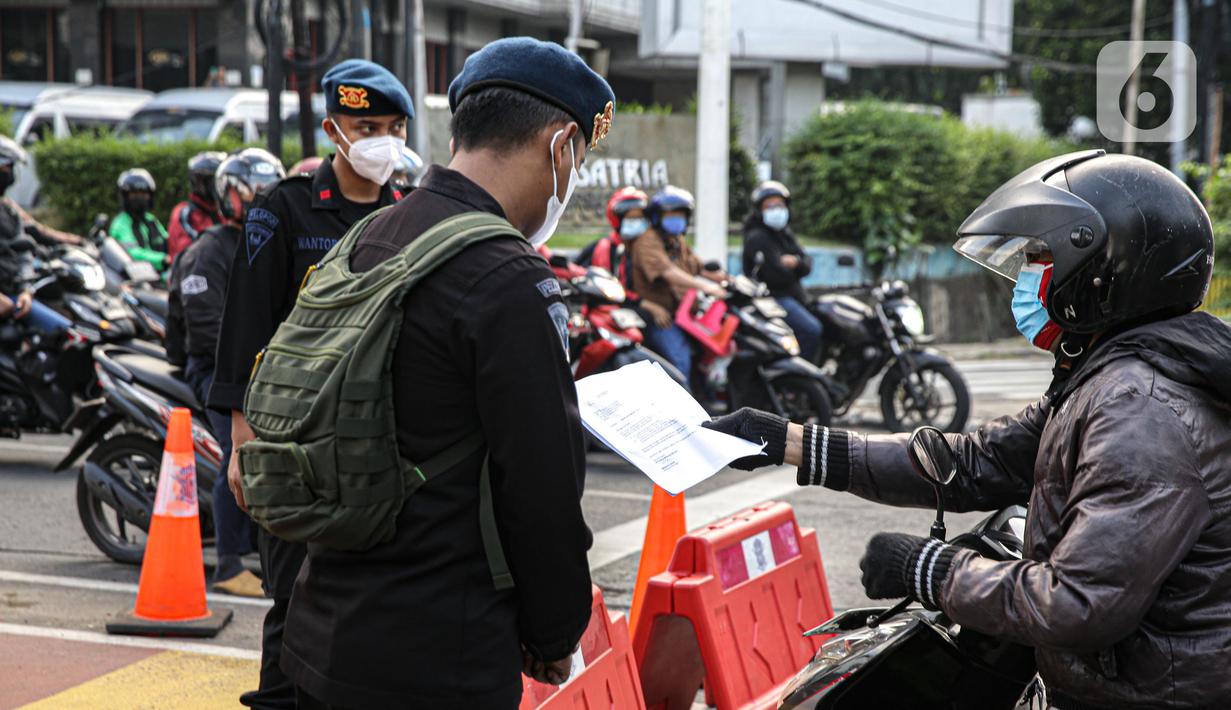 Petugas polisi mengecek dokumen pengendara saat penyekatan ruas Jalan Simatupang mengarah ke Fatmawati, Jakarta, Sabtu (10/7/2021). Penambahan titik penyekatan jalan untuk mempertegas bahwa Jakarta masih masa PPKM Darurat. (Liputan6.com/Faizal Fanani)