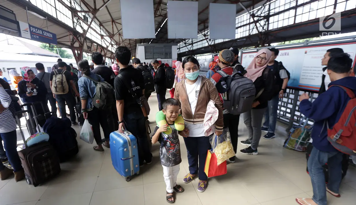 Calon penumpang menunggu kereta di Stasiun Pasar Senen, Jakarta, Jumat, (22/12). Sebanyak 17 kereta api tambahan dioperasikan guna mengantisipasi lonjakan penumpang. (Liputan6.com/Johan Tallo)