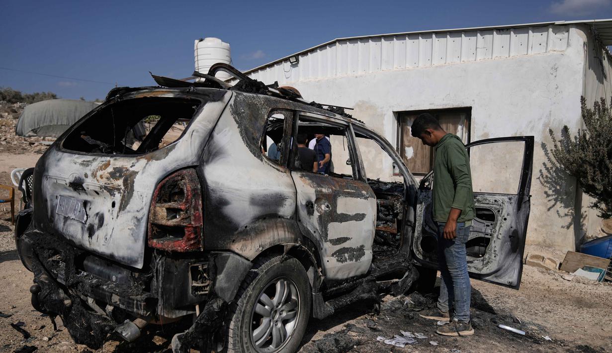 Warga Palestina memeriksa kerusakan di kawasan industri setelah serangan yang dilakukan oleh pemukim Israel pada hari sebelumnya di desa Beit Lid, dekat Tulkarm, di Tepi Barat, Rabu 12 November 2025. (AP Photo/Majdi Mohammed)