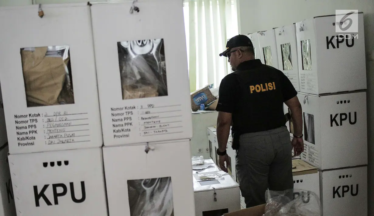Polisi mengawasi kotak logistik hasil Pemilu 2019 di Kecamatan Menteng, Jakarta, Kamis (18/4). Komisi Independen Pemilihan (KIP) menargekan distribusi logistik hasil pemilu dari TPS ke tingkat PPK di daerah selesai dalam sehari dan dilanjutkan rekapitulasi pada 19 April. (Liputan6.com/Faizal Fanani)