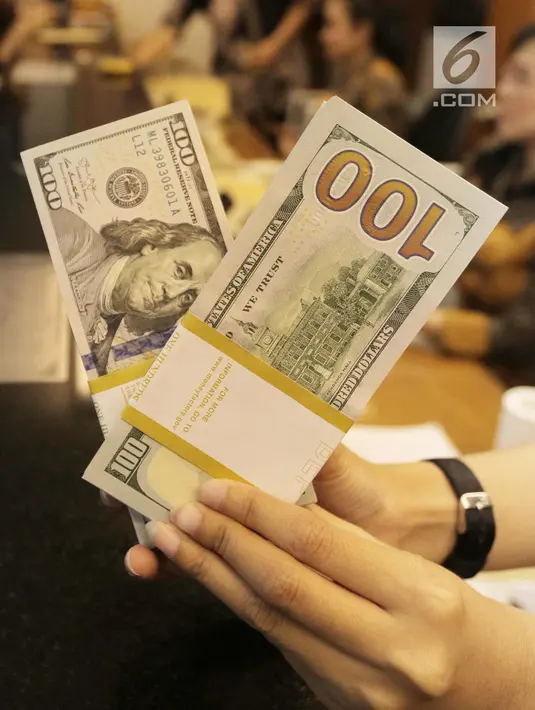 Teller menghitung mata uang dolar di penukaran uang di Jakarta, Jumat (20/4). Nilai tukar rupiah terhadap dolar Amerika Serikat (AS) mengalami pelemahan. (Liputan6.com/Angga Yuniar)