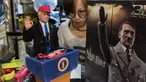 Manajer toko Monita Chan berdiri di belakang replika prototipe boneka Presiden AS Donald Trump dan pemimpin Nazi Adolf Hitler yang dibuat oleh toymaker Dragon in Dream (DiD) di Hong Kong (3/2). (AFP Photo/Anthony Wallace)