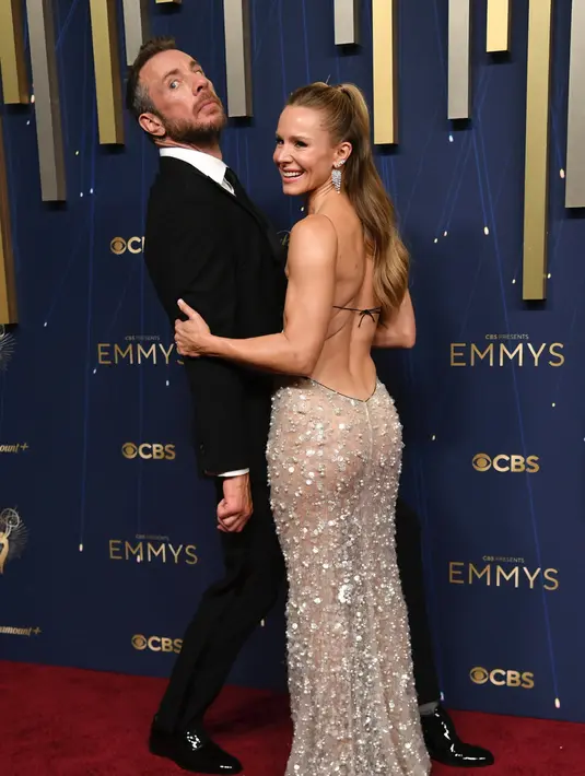 <p>Kristen Bell dan Dax Shepard di Emmy Awards 2025. Bell Bintang Nobody Wants This mengenakan gaun tanpa punggung rancangan Giorgio Armani Priv&eacute; berbahan tulle sutra putih yang seluruhnya disulam dengan payet dan kristal. Korsetnya disulam dengan manik-manik mikro-baguette Miyuki hitam. Shepard dengan setelan hitam jas.&nbsp;[Photo by Richard Shotwell/Invision/AP]</p>
