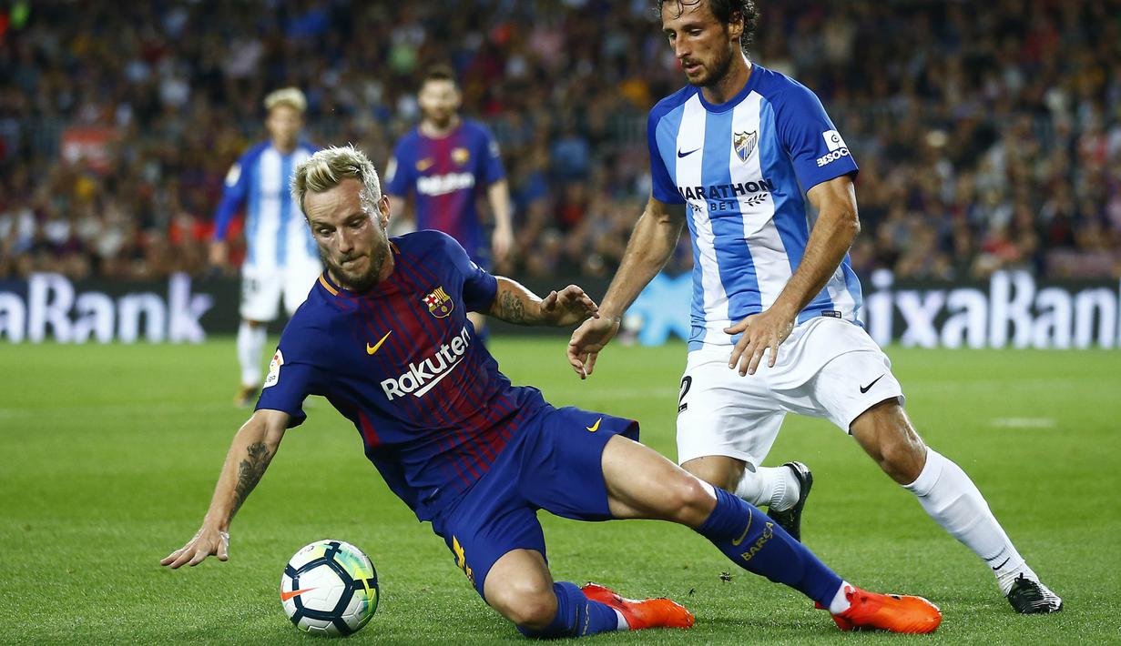 Gelandang Barcelona, Ivan Rakitic, berusaha mempertahankan bola dari bek Malaga, Paul Baysse, pada laga La Liga di Stadion Camp Nou, Barcelona, Sabtu (21/10/2017). Barcelona menang 2-0 atas Malaga. (AP/Manu Fernandez)