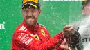 Pembalap Ferrari, Sebastian Vettel merayakan kemenangannya dalam F1 GP di Montreal, Kanada, Minggu (10/6). Kemenangan Vettel terasa spesial buat Ferrari karena meraih kemenangan perdana di seri Kanada setelah 2004. (Ryan Remiorz/The Canadian Press via AP)