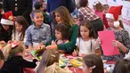 Ibu Negara AS Melania Trump membantu anak-anak membuat kartu Natal di Kampanye Program Korps Marinir AS "Toys For Tots" di Joint Base Anacostia-Bolling, Washington (13/12). Acara ini merupakan kegiatan menyambut Natal di AS. (AFP Photo/mandel Ngan)