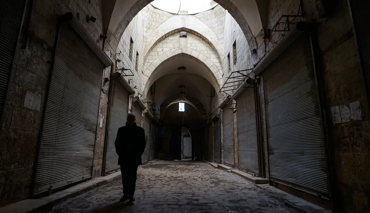 Seorang pria berjalan di lorong di pasar lama di kota tua Aleppo, Suriah (21/1). Kota tua ini meliputi area sekitar 3,5 kilometer persegi dengan lebih dari 120.000 penduduk. (AP Photo / Mstyslav Chernov)