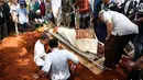 Tangis anak kedua dan anak bungsu Taufik Lala, Dinda dan Ibrahim pecah saat jenazah di masukkan liang lahat.[Foto: Bayu Herdianto/KapanLagi.com]