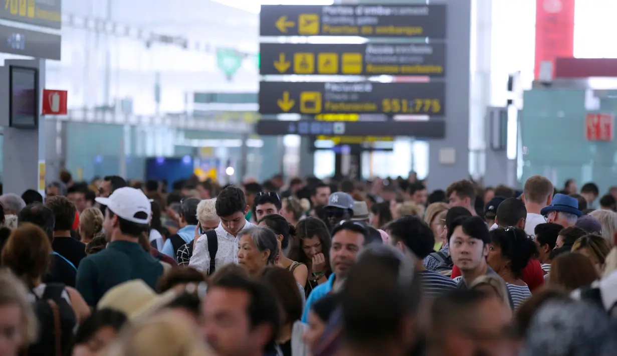 Ribuan penumpang menunggu untuk melewati kontrol keamanan di bandara Barcelona di Prat Llobregat, Spanyol  (4/8). Aksi tersebut sebagai bentuk protes terhadap bonus mereka yang belum dibayarkan pihak perusahaan. (AP Photo/Manu Fernandez)