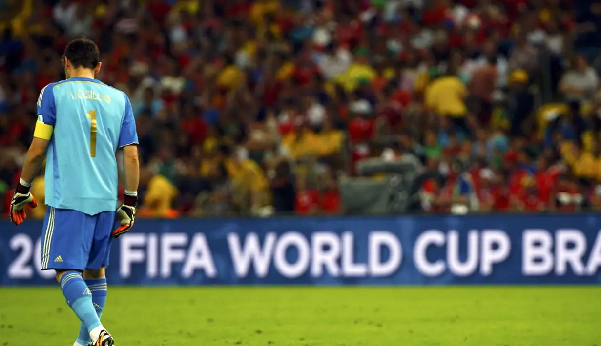 Penjaga gawang Spanyol, Iker Casillas, tertunduk meninggalkan lapangan di Stadion Maracana, Rio de Janeiro, (19/6/2014), usai dikalahkan Chile 0-2 di babak penyisihan Piala Dunia Grup B. (REUTERS/Pilar Olivares)