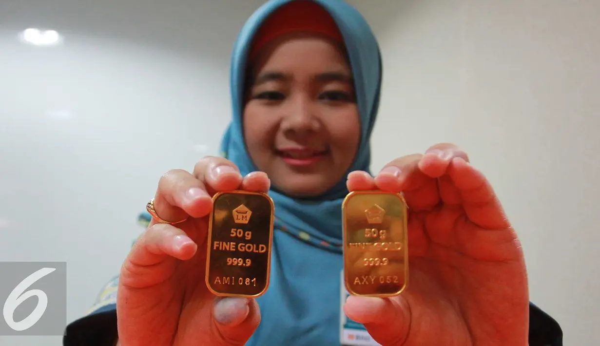 Petugas menunjukan emas batangan di Jakarta, Rabu (13/7). Harga emas batangan atau Logam Mulia milik PT Aneka Tambang Tbk (Antam) hari ini dibuka turun Rp 10.000/gram. (Liputan6.com/Angga Yuniar) 