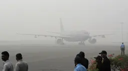 Sebuah pesawat Royal Air Force yang membawa Pangeran Charles dan istrinya, Camilla tiba di New Delhi yang diselimuti kabut asap, Rabu (8/11). Kabut asap tebal akibat polusi udara yang tinggi tengah menyelimuti India. (AP Photo/Manish Swarup)