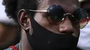 Masyarakat Papua mengenakan masker saat memperingati Operasi Trikora 19 Desember 1961 di Patung Kuda, Jakarta, Sabtu (19/12/2020). Salah satu tuntutan massa adalah penghentian segala bentuk diskriminasi dan intimidasi terhadap mahasiswa Papua Barat. (Liputan6.com/Johan Tallo)