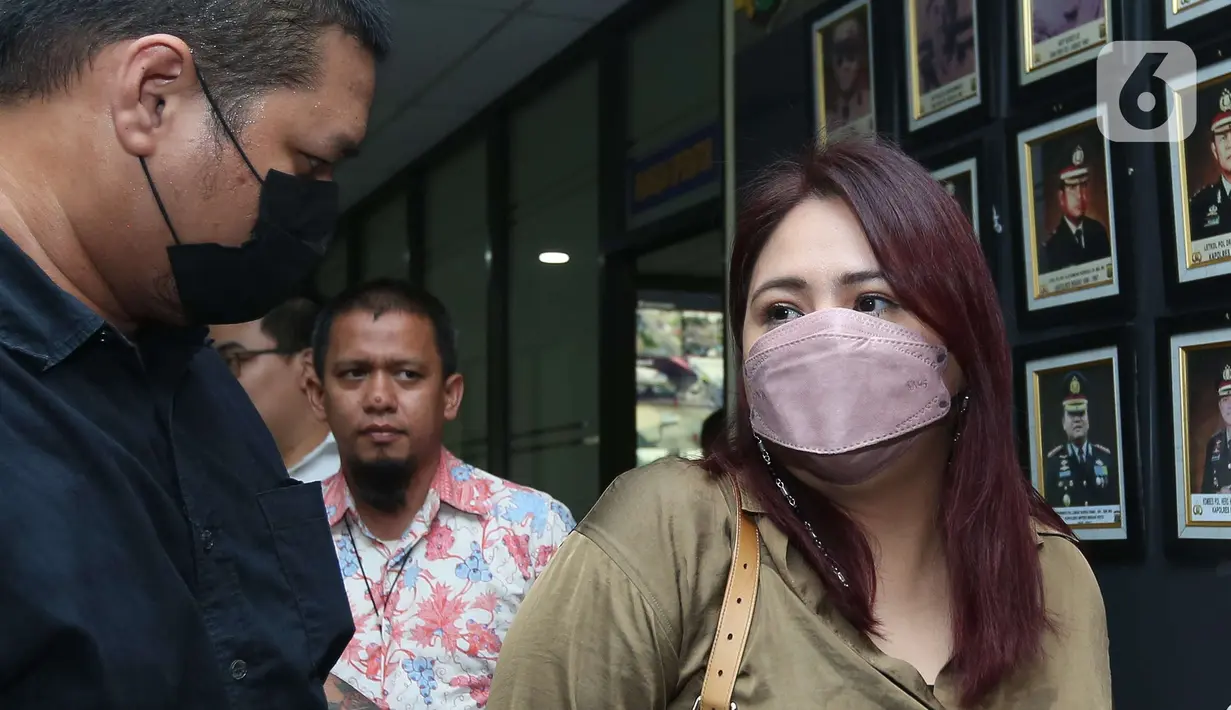 Penyanyi  Audy Item usai menjalani pemeriksaan di Polres Metro Bekasi Kota, Jawa Barat, Selasa (21/6/2022). Audy diperiksa sebagai saksi atas dugaan pengeroyokan yang melibatkan suaminya, Iko Uwais. (Liputan6.com/Herman Zakharia)