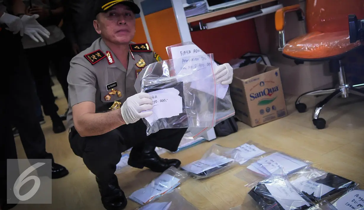 Kapolda Mochamad Iriawan menunjukkan barang bukti pungutan liar (pungli) saat operasi tangkap tangan (OTT) di Kementerian Perhubungan, Jakarta, Selasa (11/10). (Liputan6.com/Faizal Fanani)