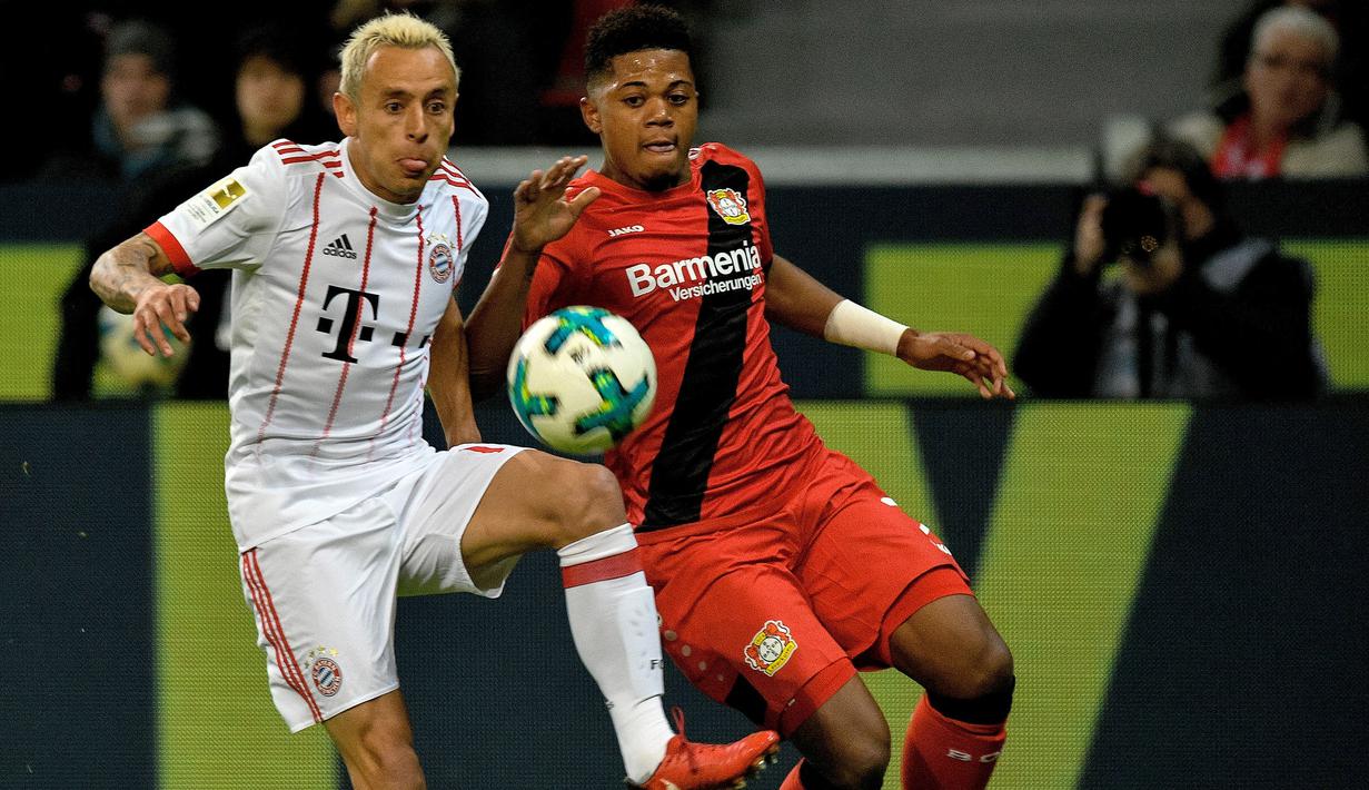 Aksi pemain Leverkusen, Leon Patrick Bailey (kanan) berebut bola dengan pemain Bayern Munchen, Rafinha pada lanjutan Budesliga di Bay Arena, Laverkusen, (12/1/2018). Bayern Munchen menang 3-1. (AFP/Sascha Schuermann)