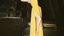 Slit dress kuning juga pernah dikenakan Cinta dipadukam heels dengan strap keemasan. Credit: (@claurakiehl)