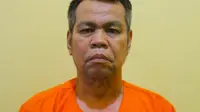 Wakil Bupati Bengkalis non aktif, Muhammad, memakai baju tahanan Polda Riau. (Liputan6.com/Istimewa)