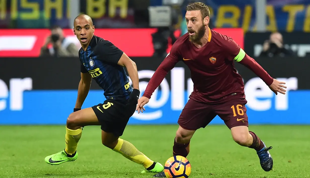 Gelandang AS Roma, Daniele De Rossi, berusaha melewati gelandang Inter Milan, Joao Mario. Pada laga ini kedua klub sama-sama memakai formasi andalan mereka 3-4-2-1. (AFP/Giuseppe Cacace)