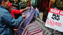 Beberapa calon pembeli memilih busana muslim yang ditawarkan dengan harga terjangkau di salah satu toko yang ada di kawasan Pasar Baru, Jakarta, (25/7/2014). (Liputan6.com/Faizal Fanani)