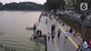 Foto udara memperlihatkan aktivitas warga di pedestrian Danau Sunter, Jakarta, Sabtu (27/6/2020). Beragam aktivitas dilakukan warga sambil menikmati waktu sore di area Danau Sunter, Jakarta. (Liputan6.com/Helmi Fithriansyah)
