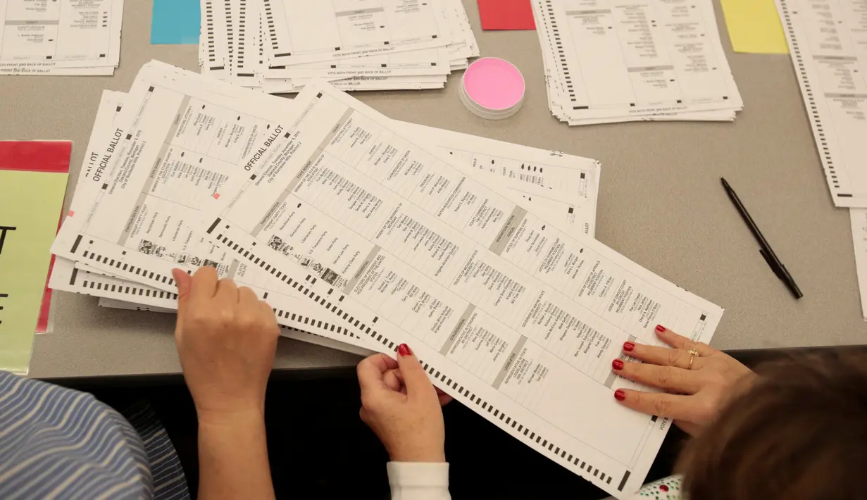 Selembaran surat suara pemilu yang diteliti kembali untuk memastikan tidak atau adanya kecurangan yang terjadi pada pemilihan Presiden AS, Michigan, Amerika Serikat (5/12). (Reuters/Rebecca Cook)