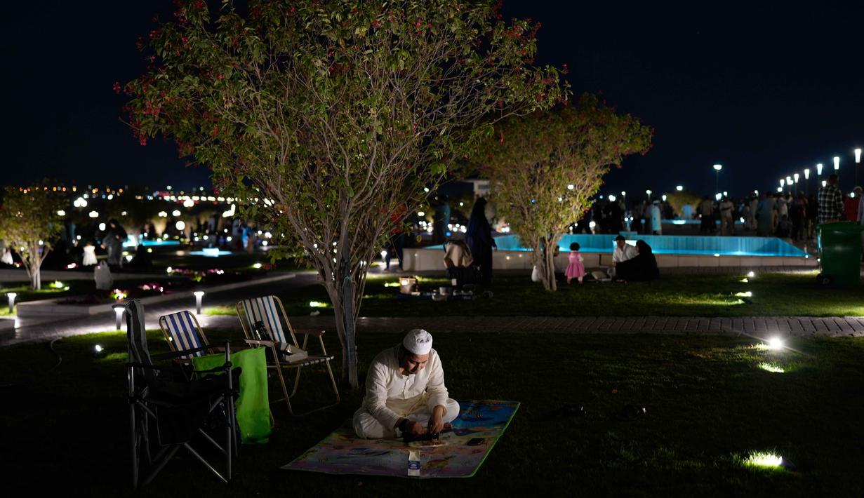 Masjid ini terbuka untuk non-Muslim dengan jalur pejalan kaki dan area pandang khusus untuk menikmati keindahan arsitekturnya. Tampak dalam foto, seorang pria Muslim makan setelah berbuka puasa selama bulan suci Ramadan di Masjid Agung Sharjah, dekat Dubai, Uni Emirat Arab, Jumat 27 Februari 2026. (AP Photo/Altaf Qadri)