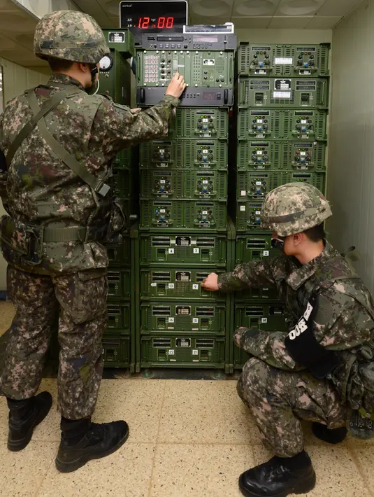 Tentara Korsel menyesuaikan pengeras suara yang disetel tepat di sebelah selatan zona demiliterisasi, Yeoncheon, Jumat (8/1/2016). Korsel melakukan siaran propaganda sebagai balasan atas klaim Pyongyang yang sedang menguji bom hidrogen. (YONHAP/AFP)