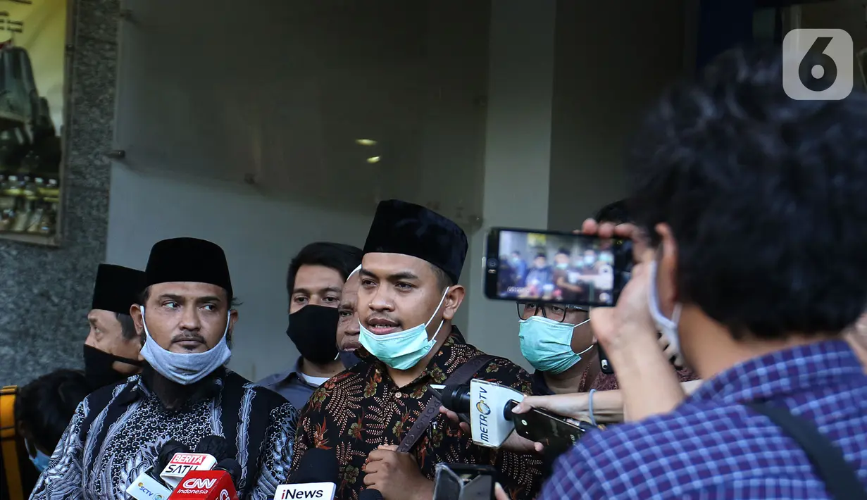 Kuasa hukum Muhammad Rizieq Shihab, Aziz Yanuar (tengah) saat memberi keterangan kepada media di Polda Metro Jaya, Jakarta, Selasa (1/12/2020). Muhammad Rizieq Shihab belum bisa hadir dalam pemeriksaan dikarnakan kondisi kesehatannya masih kurang sehat. (Liputan6.com/Herman Zakharia)