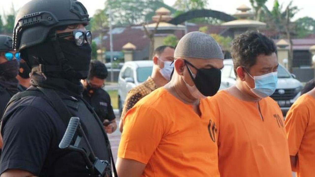Kompol YC (masker hitam), perwira Polda Riau yang terekam CCTV menghisap sabu di dalam mobil.