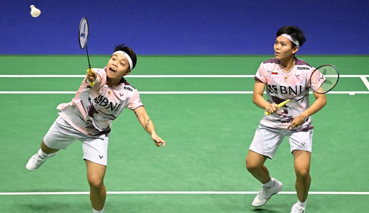 Ganda putri Indonesia, Apriyani Rahayu (kiri) dan Siti Fadia Silva Ramadhanti berusaha menjangkau bola saat menghadapi wakil Malaysia, Pearly Tan/Thinaah Muralitharan pada laga final ganda putri Hong Kong Open 2023 di Hong Kong Coliseum, Minggu (17/9/2023) siang WIB. (AFP/Peter Parks)