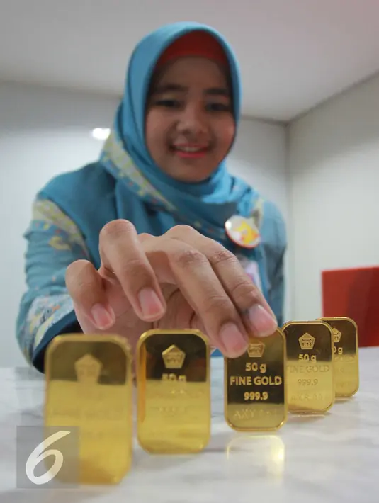 Petugas menunjukan emas batangan di Jakarta, Rabu (13/7). Harga buyback emas batangan dibuka turun di Rp 8.000/gram. (Liputan6.com/Angga Yuniar)