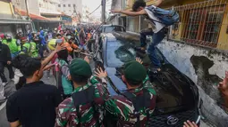 Massa merusak dan membakar kendaraan roda empat yang terparkir di depan Mako Korps Brimob Polda Metro Jaya di kawasan Kwitang, Jakarta Pusat, Jumat (29/8/2025). (merdeka.com/Arie Basuki)
