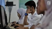 Sejumlah siswa kelas XII mengerjakan soal Bahasa Indonesia saat mengikuti Ujian Nasional Berbasis Komputer (UNBK) di SMKN 50 Jakarta, Senin (25/3). Kemendikbud mengatur UNBK tingkat SMK dilaksanakan serentak dalam empat hari mulai 25 sampai 28 Maret 2019. (merdeka.com/Iqbal S. Nugroho)