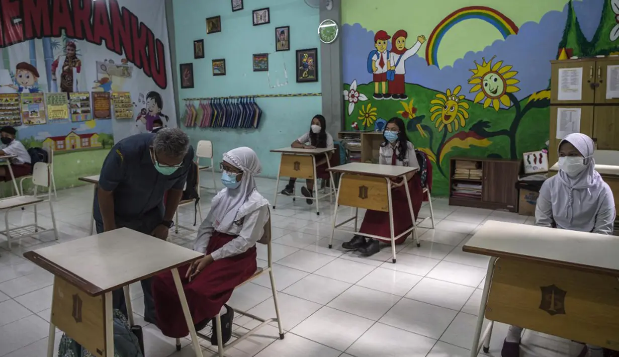 Siswa mengikuti pembelajaran tatap muka (PTM) di sebuah sekolah di Surabaya, Jawa Timur, Senin (6/9/2021). Pemerintah kembali membuka sekolah di tengah pandemi COVID-19. (JUNI KRISWANTO/AFP)