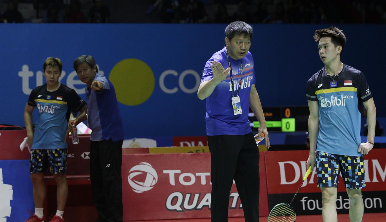 Pelatih Indonesia, Aryono Minarat, memeberi arahan kepada Kevin Sanjaya, saat melawan wakil Jepang, Takuto Inoue/Yuki Kaneko, pada Indonesia Open 2019 di Istora, Jakarta, Selasa (16/7). Pasangan Indonesia menang 20-22, 21-16, 21-14. (Bola.com/M Iqbal Ichsan)
