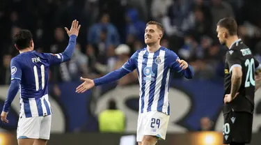 Pemain Porto Toni Martinez (tengah) merayakan dengan rekan setimnya Pepe dilihat pemain Lazio Mattia Zaccagni setelah mencetak gol ke gawang Lazio pada pertandingan Liga Europa di Stadion Dragao, Porto, Portugal, 17 Februari 2022. Porto menang 2-1. (AP Photo/Luis Vieira)