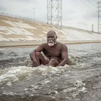 Garbiel, seorang tunawisma di Los Angeles, terlihat mandi di sungai. (Exclusivepix Media)