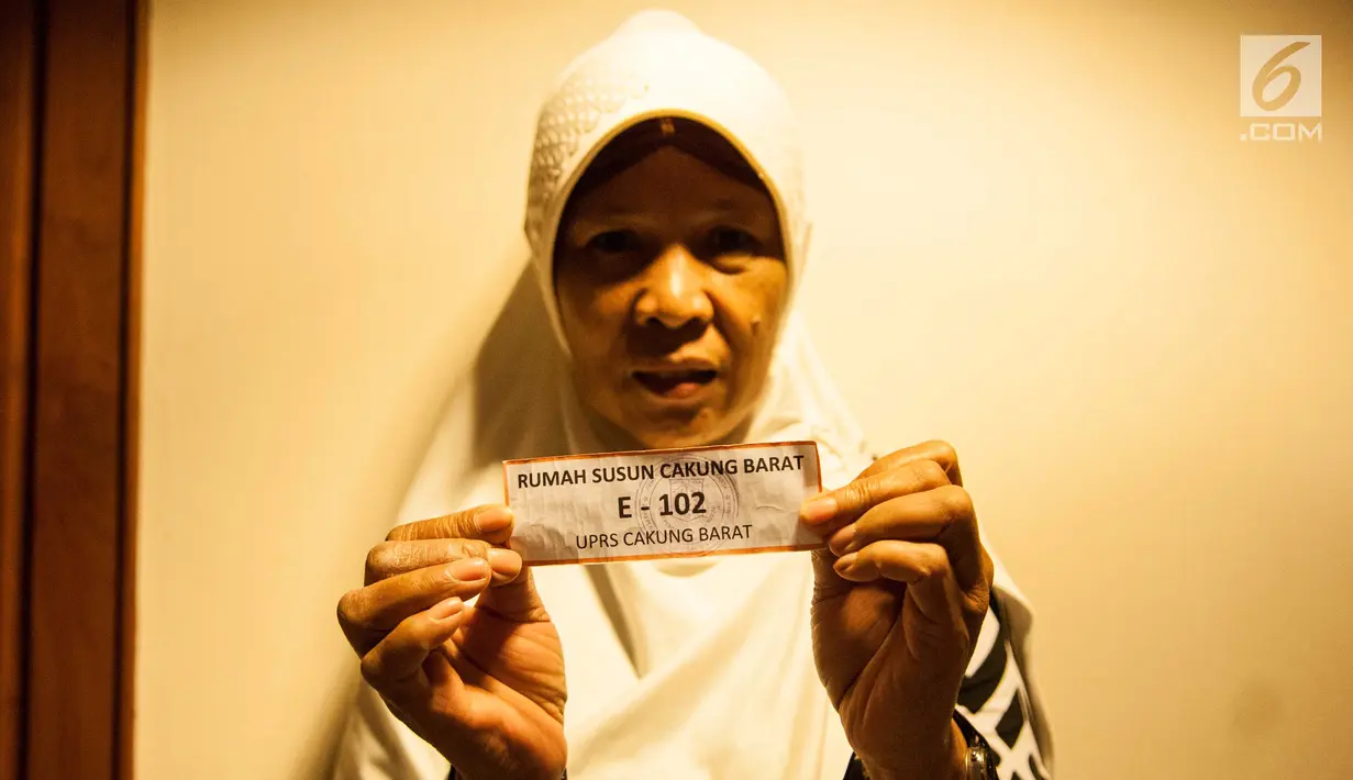 Warga menunjukan undian Rumah Susun di Balai Kota, Jakarta, Senin (26/5). Mereka yang diundang untuk mengikuti pengundian hari ini adalah warga Bukit Duri, yang akan dipindahkan ke Rusun Cakung Barat. (Liputan6.com/Gempur M Surya)