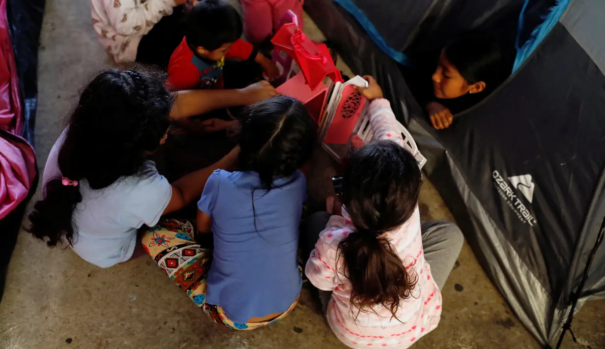 Anak-anak imigran bermain di luar tenda tempat penampungan di Tijuana, Meksiko 6 April 2019. Rombongan migran Amerika Tengah mencapai kota perbatasan antara Meksiko dan AS tersebut  untuk mencari suaka akibat kekerasan, pembunuhan dan kemiskinan yang mengancam mereka. (REUTERS/Carlos Jasso)