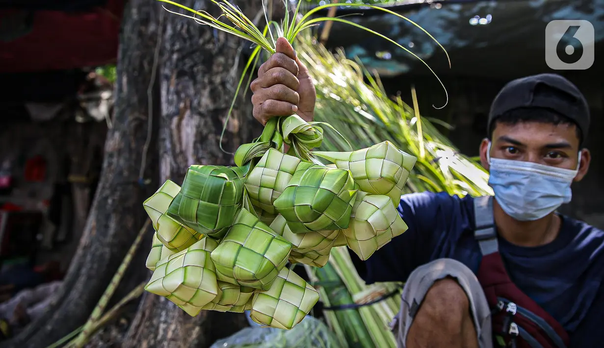 Pedagang menunjukkan cangkang ketupat di kawasan Palmerah, Jakarta, Minggu (18/7/2021). Pemberlakuan PPKM Darurat membuat penjualan cangkang ketupat jelang Idul Adha tahun ini sepi pembeli. (Liputan6.com/Faizal Fanani)