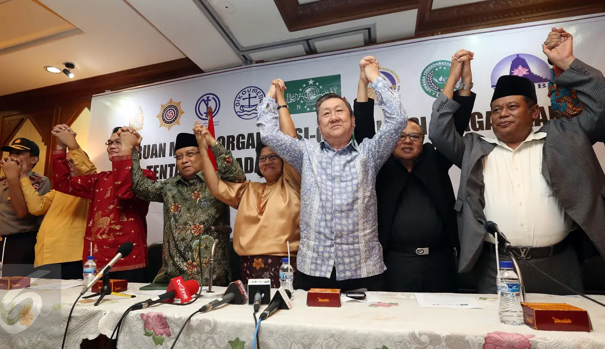 Ketua Umum PBNU Said Aqil Siradj mengangkat tangan bersama pemuka agama lain usai pembacaan seruan moral tentang Pilkada DKI Jakarta putaran kedua di Jakarta, Senin (17/4). (Liputan6.com/Johan Tallo)