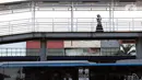 Warga melintas di JPO menuju halte transjakarta Harmoni, Jakarta, Kamis (1/10/2020). Pemberlakuan PSBB II berdampak pada menurunya pengguna transjakarta, selama dua pekan penerapan jumlah pengguna transjakarta tercatat 3.632.047. (Liputan6.com/Helmi Fithriansyah)