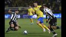 Pemain Al Nassr, Cristiano Ronaldo (tengah), berusaha mengontrol bola dibayangi dua pemain Al Shabab, Ever Banega (kiri) dan Fawaz Al-Sagour, dalam laga perempat final King's Cup Arab Saudi 2023 yang digelar di Al Shabab Club Stadium, Selasa (12/12/2023) dini hari WIB. (AFP/Str)