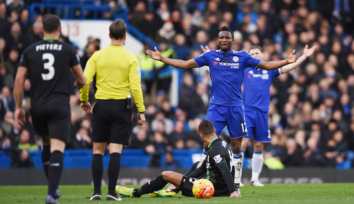 Gelandang Chelsea, John Obi Mikel mendapat teguran dari wasit usai menjatuhkan pemain Stoke. Pada laga itu wasit mengeluarkan tiga kartu kuning. (Reuters/Tony O'Brien)