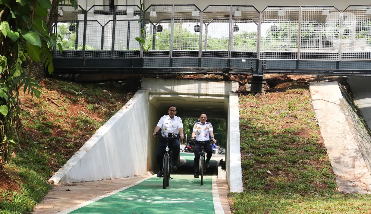 Gubernur DKI Jakarta Anies Baswedan bersepeda di jalur sepeda saat soft launching fasilitas pejalan kaki dan pesepeda pada proyek pembangunan dan penataan kawasan Semanggi di Taman Semanggi, Jakarta, Rabu (12/10/2022). Gubernur DKI Jakarta Anies Baswedan menyatakan pembangunan fasilitas pejalan kaki dan jalur sepeda itu bertujuan untuk memberikan ruang interaksi dan oase baru bagi warga Ibu Kota dan sekitarnya.  (Liputan6.com/Herman Zakharia)