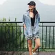 Enzy Storia tampil mengenakan oversize denim sebagai outer dipadukan inner hitam serasi dengan kalung choker yang saat itu tengah tren. Ia memadukannya dengan mini skirt hitam putih motif tribal dan mengenakan topi cap hitam.  [@enzystoria]