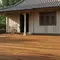 Perpaduan Lantai Teras Motif Kayu dengan Rumah Desa Sederhana/AI