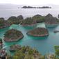 Pengunjung berada di Pulau Piaynemo di Kabupaten Raja Ampat, Papua Barat. Pulau Piaynemo juga sering disebut sebagai Pulau Wayag kecil. (Liputan6.com/Zulfi Suhendra)